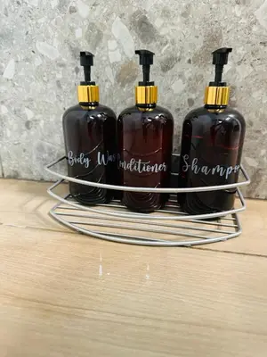 three bottles of soap sitting on a tray on a table at Kallisti 2bd Central Stay - Wow View in Nicosia