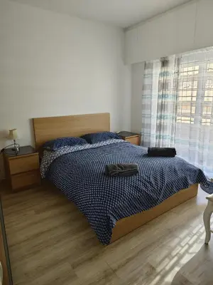 a bedroom with a bed with a blue comforter at Anne 3 Bedroom Apartment in Larnaka