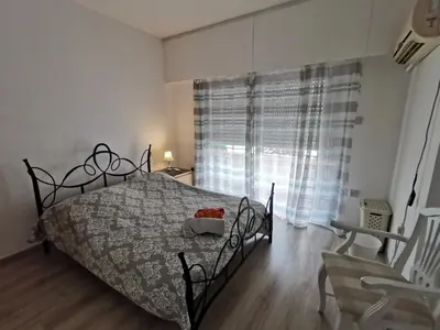 a bedroom with a bed and a large window at Anne 3 Bedroom Apartment in Larnaka