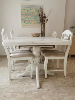 a white dining table and chairs with a vase on top at Anne 3 Bedroom Apartment in Larnaka