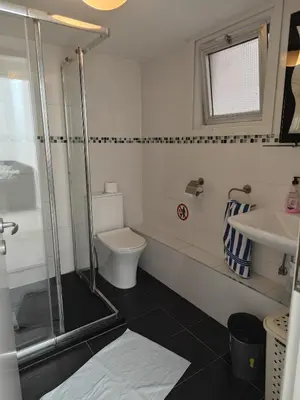 a bathroom with a shower and a toilet and a sink at Anne 3 Bedroom Apartment in Larnaka