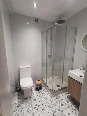 a bathroom with a shower and a toilet and a sink at Anne 3 Bedroom Apartment in Larnaka