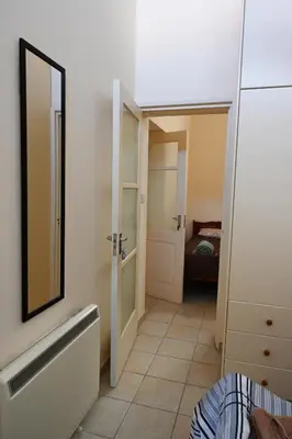 a small bathroom with a mirror and a door at ThemisHouse in Omodos