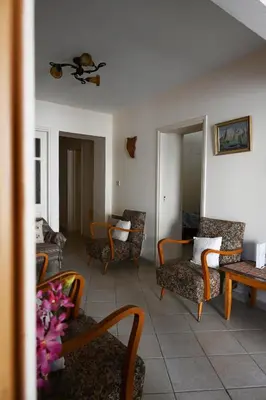 a living room with couches and chairs and a table at ThemisHouse in Omodos