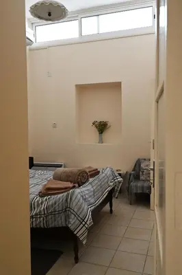 a bedroom with a bed in a room with a window at ThemisHouse in Omodos