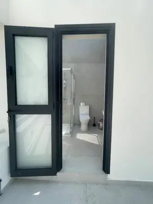an open door to a bathroom with a toilet at Tiffany Mare villa in Ayia Napa