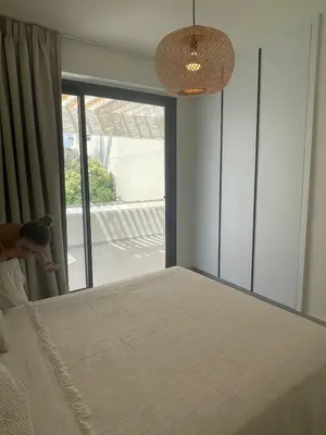 a bedroom with a bed and a large window at Tiffany Mare villa in Ayia Napa