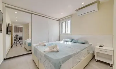 a bedroom with a large bed with towels on it at Deluxe Apt - 500m Nissi Beach! in Ayia Napa