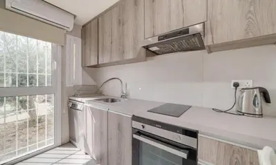 a kitchen with a sink and a counter top at Deluxe Apt - 500m Nissi Beach! in Ayia Napa