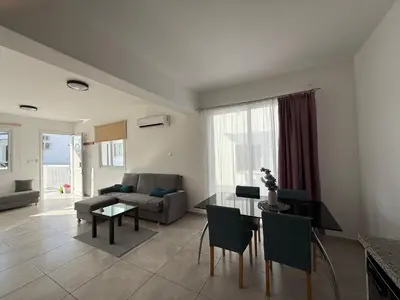 a living room with a table and a couch at Sun & Sea House in Paralimni