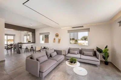 a living room with two couches and a table at Ayia Napa Bay View Villa 6 in Ayia Napa
