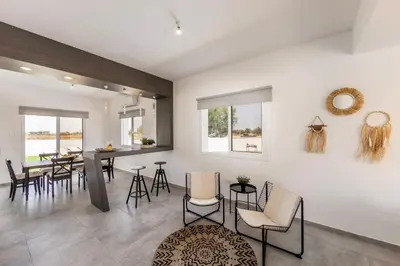 a kitchen and dining room with a table and chairs at Ayia Napa Bay View Villa 6 in Ayia Napa