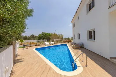 a swimming pool on a deck next to a house at Ayia Napa Bay View Villa 6 in Ayia Napa