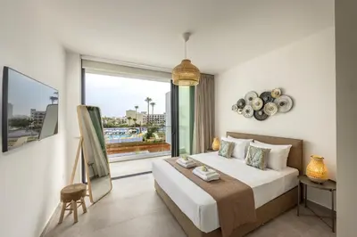 a bedroom with a bed and a large window at Protaras Aqua Pearl Villa 3 in Protaras