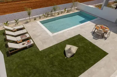 an overhead view of a swimming pool with a table and chairs at Protaras Aqua Pearl Villa 3 in Protaras