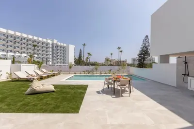 a patio with a table and chairs and a building at Protaras Aqua Pearl Villa 3 in Protaras