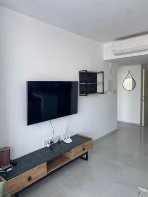 a living room with a large flat screen tv on a wall at Abelia Sea View in Paralimni