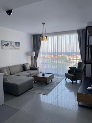 a living room with a couch and a table at Abelia Sea View in Paralimni