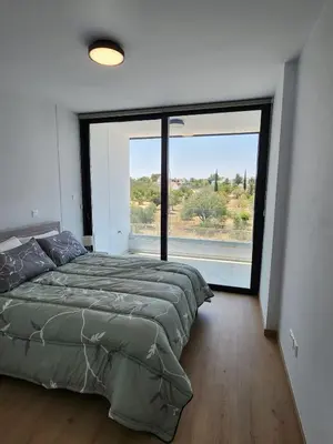 a bedroom with a bed and a large window at Infinity Luxury Mansions in Yeri