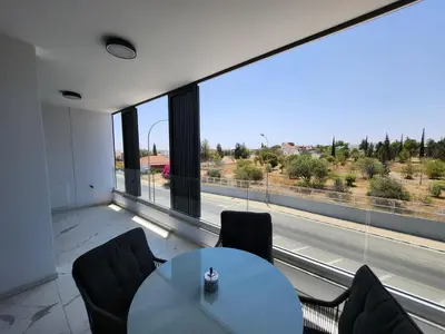a room with a table and chairs and a large window at Infinity Luxury Mansions in Yeri