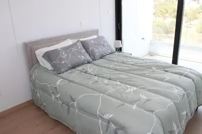 a large bed in a bedroom with a large window at Infinity Luxury Mansions in Yeri