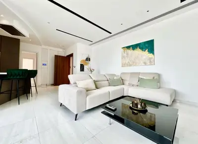 a living room with a white couch and a table at Luxury 2BR Center 360 Nicosia with pool, gym, sauna in Nicosia
