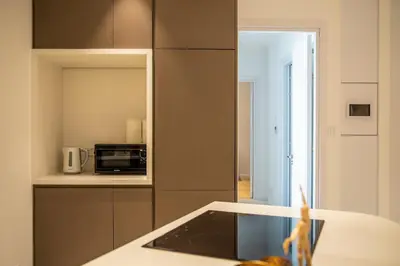 a kitchen with a counter and a microwave in it at Luxury 2BR Center 360 Nicosia with pool, gym, sauna in Nicosia
