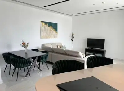 a living room with a couch and a table and chairs at Luxury 2BR Center 360 Nicosia with pool, gym, sauna in Nicosia