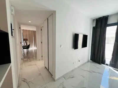 a hallway with white walls and a large mirror at Nicosia City Centre City Vibes Luxury 1BD in Nicosia