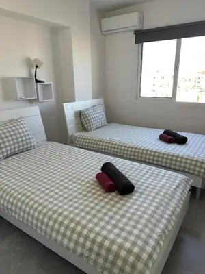 two beds sitting next to each other in a room at Near Finikoudes Beach 3 in Larnaka