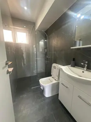 a bathroom with a toilet and a shower and a sink at Near Finikoudes Beach 3 in Larnaka