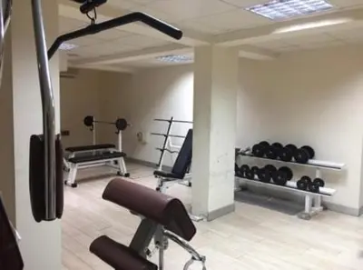 a gym with dumbbells and weights in a room at Seasons Retreat with pool and gym-2BR in Voroklini