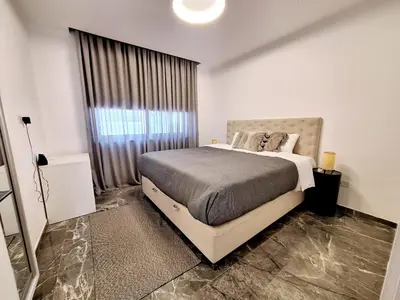 a bedroom with a bed and a large window at Panorama Luxury Summer Villa in Protaras