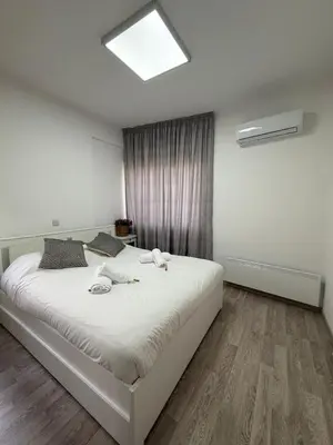 a bedroom with a large white bed in a room at Stylish 2BR in City Center of Limassol in Limassol