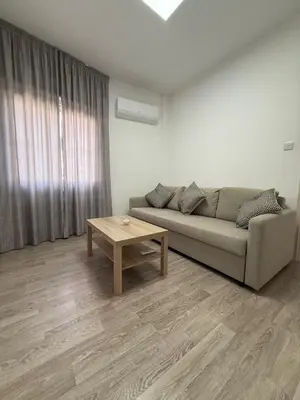 a living room with a couch and a coffee table at Stylish 2BR in City Center of Limassol in Limassol