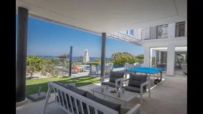 a living room with a ping pong table on a patio at Villa Prcv614, Luxury 6bdr Protaras Villa with Pool and Panoramic Sea views in Protaras