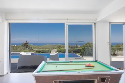 a pool table in a living room with a view at Villa Prcv614, Luxury 6bdr Protaras Villa with Pool and Panoramic Sea views in Protaras
