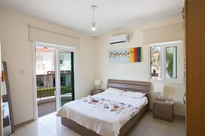 a bedroom with a bed with two candles on it at Protaras Mesogeios Villa Me16 Beachfront Villa in Protaras Center in Protaras