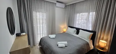 a bedroom with a bed with two towels on it at Trendy Neapolis Beach Apartment in Limassol