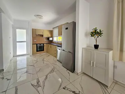 a kitchen with marble floors and a stainless steel refrigerator at Nissi beach villa Azure in Ayia Napa