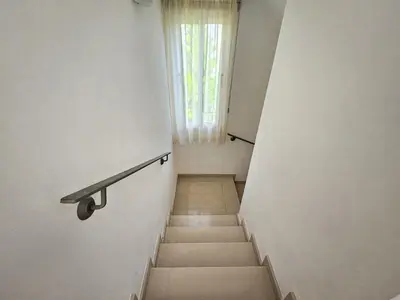 a stairway with a railing and a window at Nissi beach villa Azure in Ayia Napa