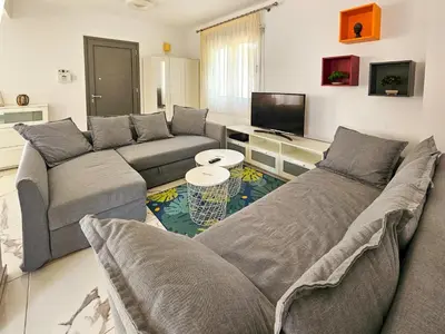 a living room with two couches and a tv at Nissi beach villa Azure in Ayia Napa