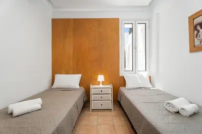 two beds in a room with two windows at Villa Zina by Ezoria Villas in Meneou