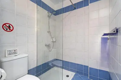 a bathroom with a shower and a toilet and a tub at Villa Zina by Ezoria Villas in Meneou