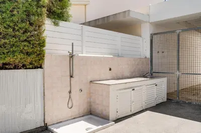 a white bathroom with a shower and a sink at Villa Zina by Ezoria Villas in Meneou
