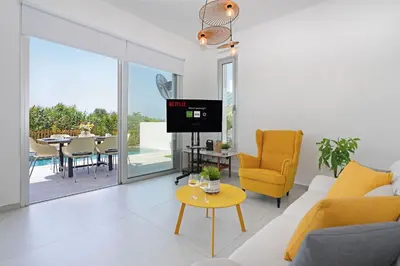 a living room with a couch and a table at MAREN - 250m from Golden Sandy Beach in Paralimni