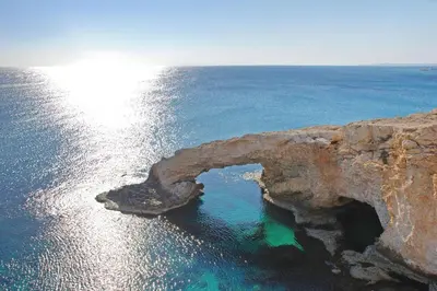 an arch in the rocks in the ocean at MAREN - 250m from Golden Sandy Beach in Paralimni