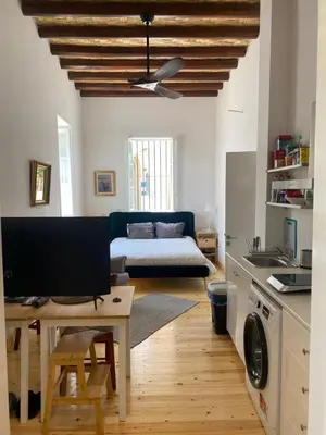 a living room with a couch and a table at ToHaniMou - Kamara Medium Studio in Nicosia