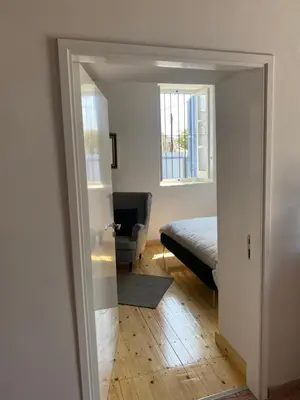 a bedroom with a bed and a door to a room at ToHaniMou - Kamara Medium Studio in Nicosia