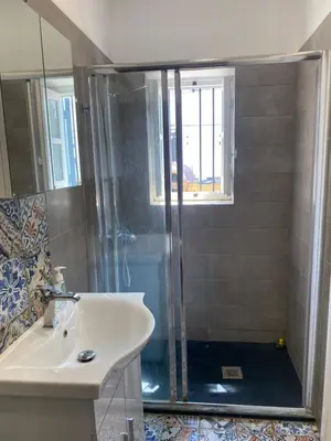 a bathroom with a shower and a sink at ToHaniMou - Kamara Medium Studio in Nicosia